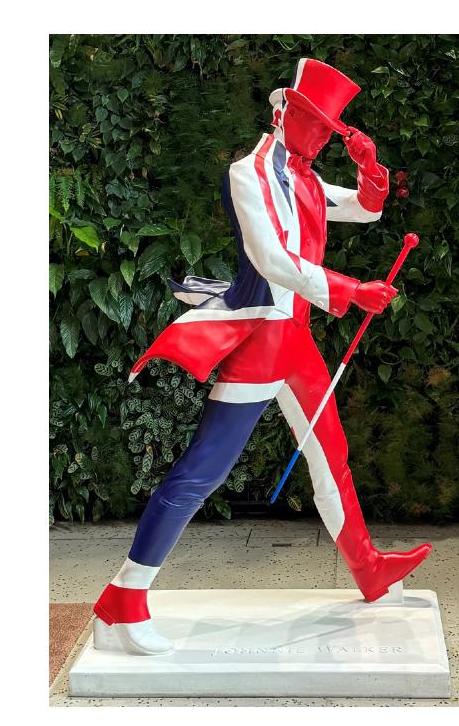 A Johnnie Walker striding-man statue dressed in a Union Jack suit, seen outside during our London research trip